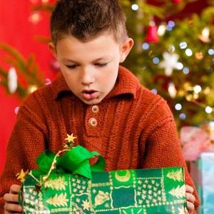 10718382 - christmas - happy little boy with xmas present on christmas eve