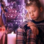 47535158 - sad little boy waiting for christmas presents